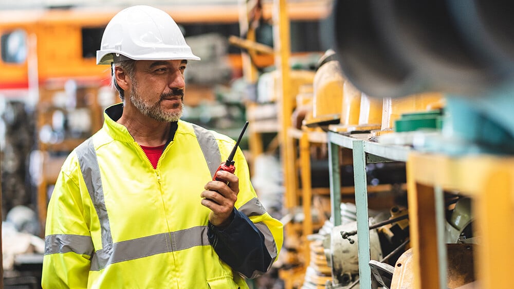 Warehouse employee with a walkie talkie