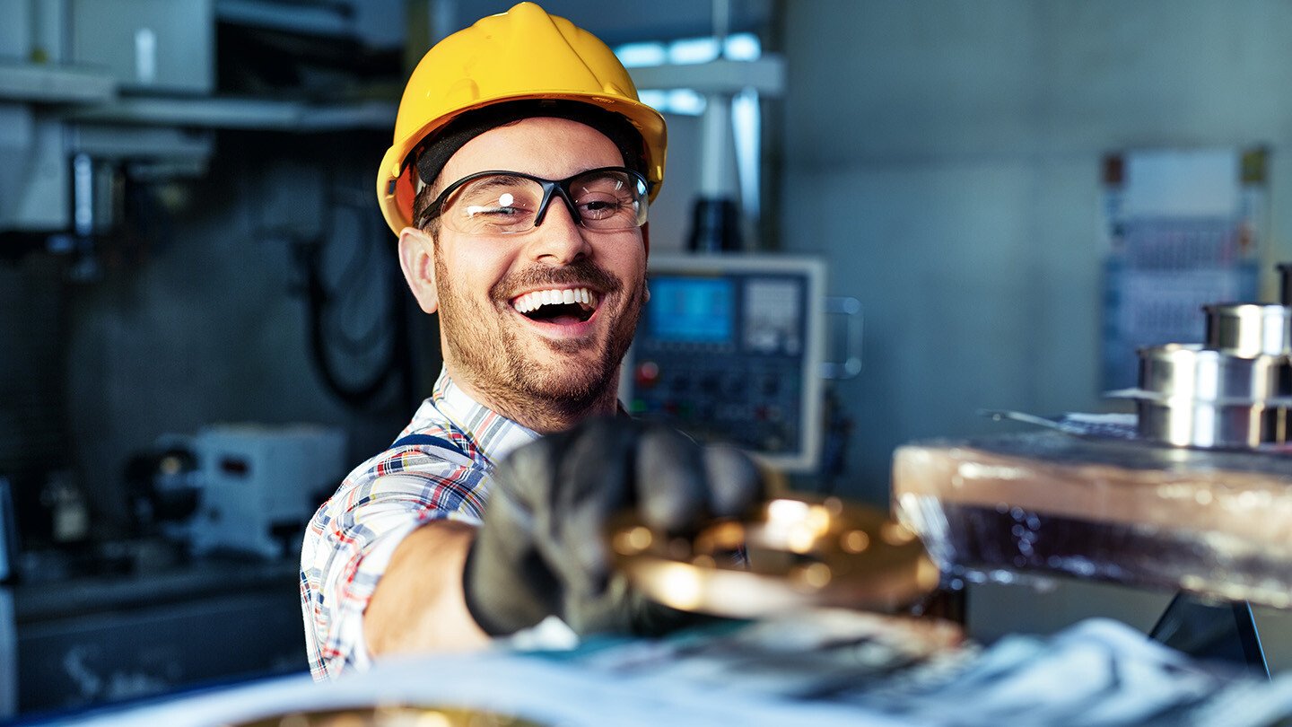 smiling technician repairing equipment