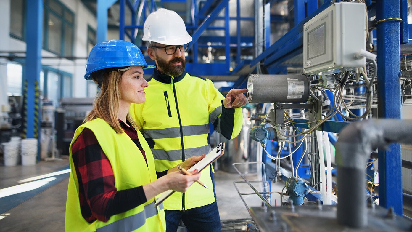 two metrology service technicians observing equipment